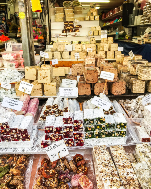 variety of colorful foods like flavored halva at market in Israel