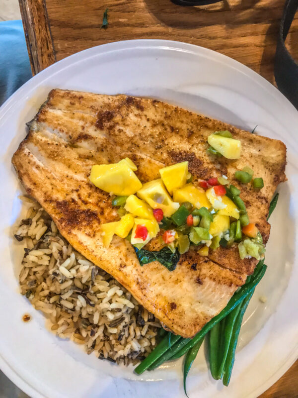 Fish and rice entree on a white plate at the Chisos Mountain Lodge restaurant