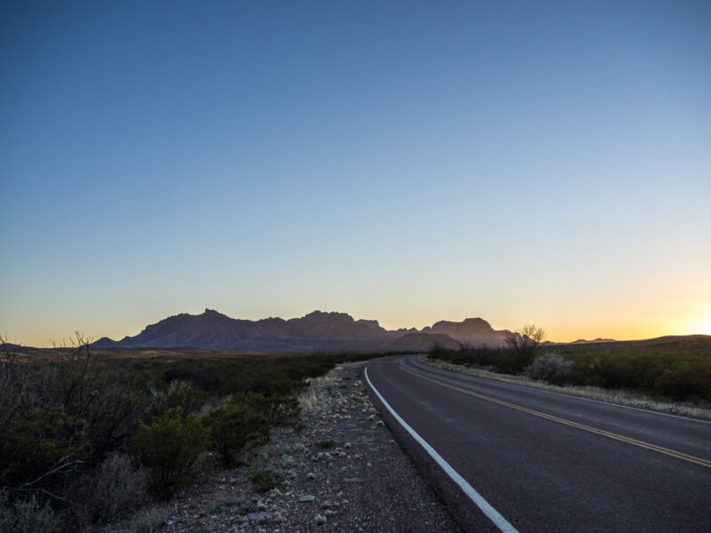 Open road curving toward mountains in Big Bend National Park, Texas
