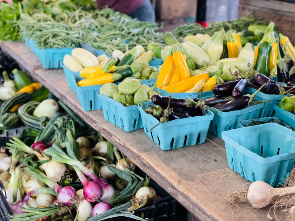 brightly colored produce display at Ithaca Farmers Market - things to do in Finger Lakes with kids