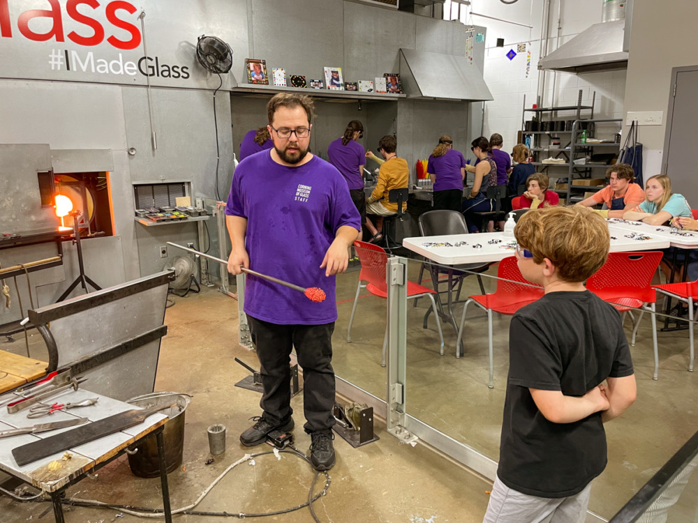 boy and gaffer making a glass sculpture in the studio at Corning Museum of Glass - things to do in Finger Lakes with kids