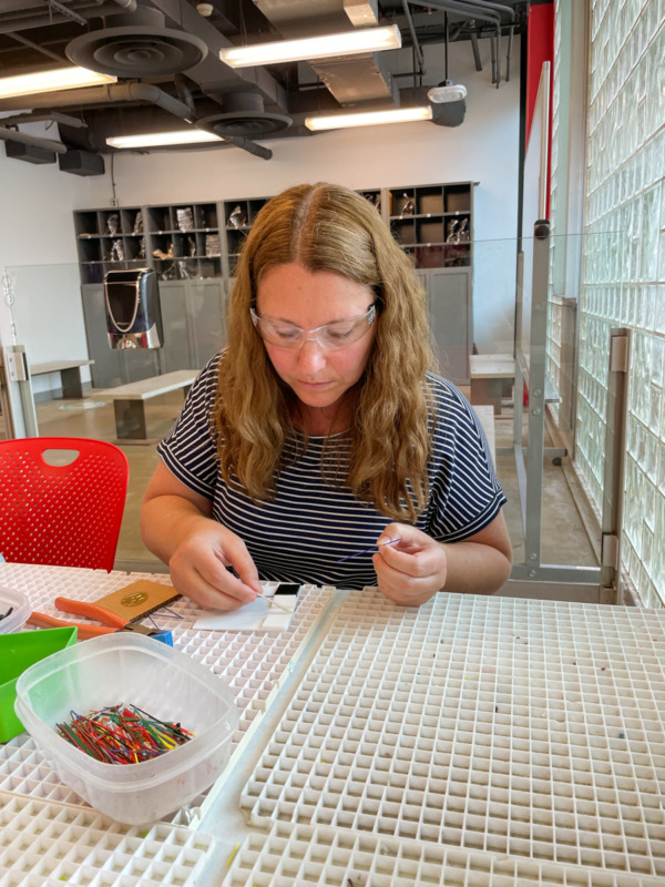 woman making glass art in the studio at Corning Museum of Glass - things to do in Finger Lakes with kids