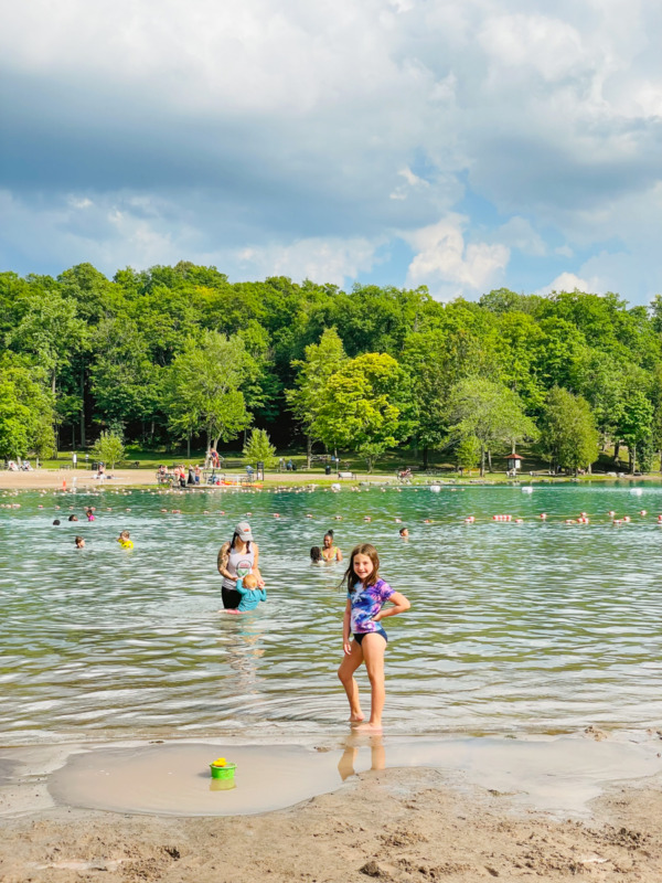 young girl standing in shallow water at Green Lakes State Park NY - things to do in Finger Lakes with kids