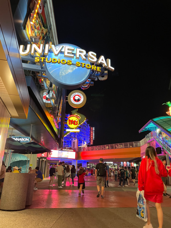 People walking at night at Universal CityWalk with kids in Orlando