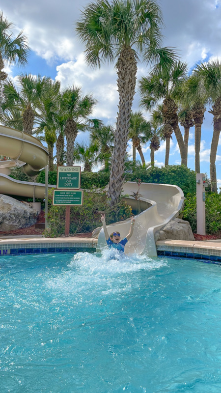 Boy coming down water slide at Hyatt Regency Grand Cypress with kids