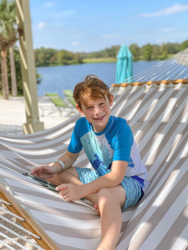 Boy relaxing in hammock at Hyatt Regency Grand Cypress Orlando Florida