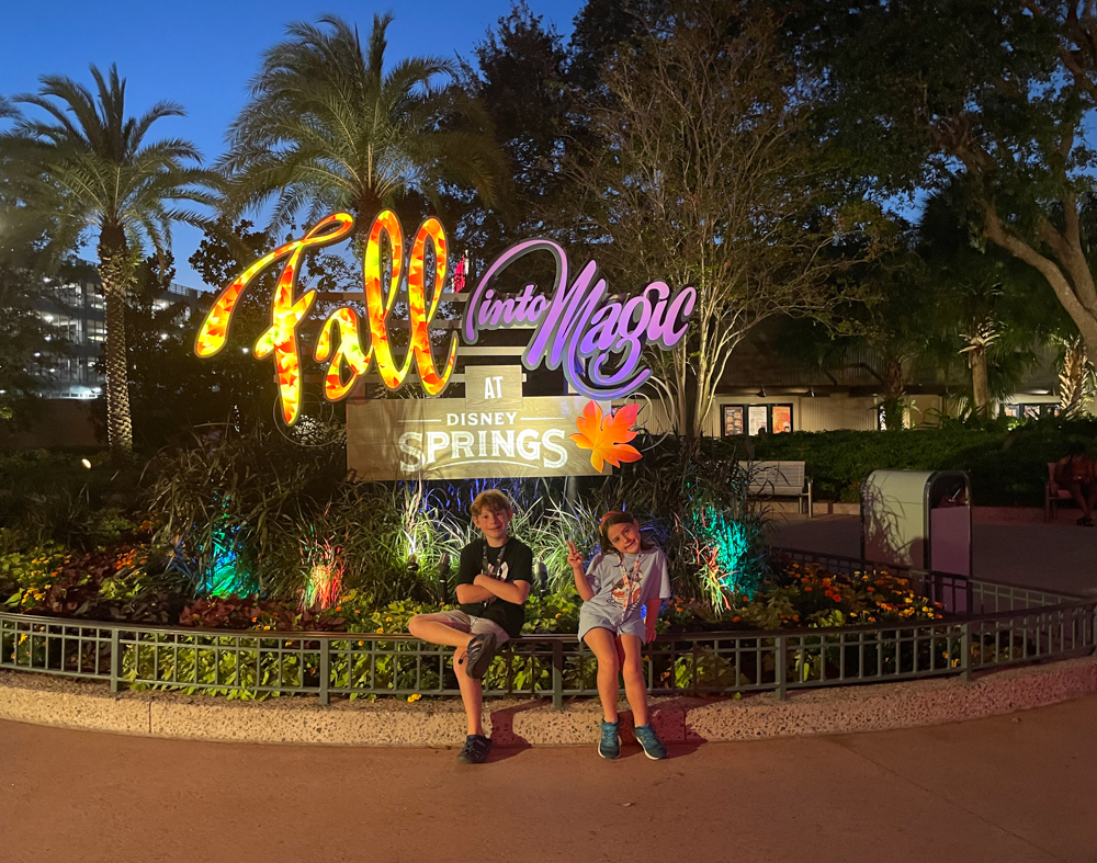 Two children posing in front of Disney Springs sign in Orlando