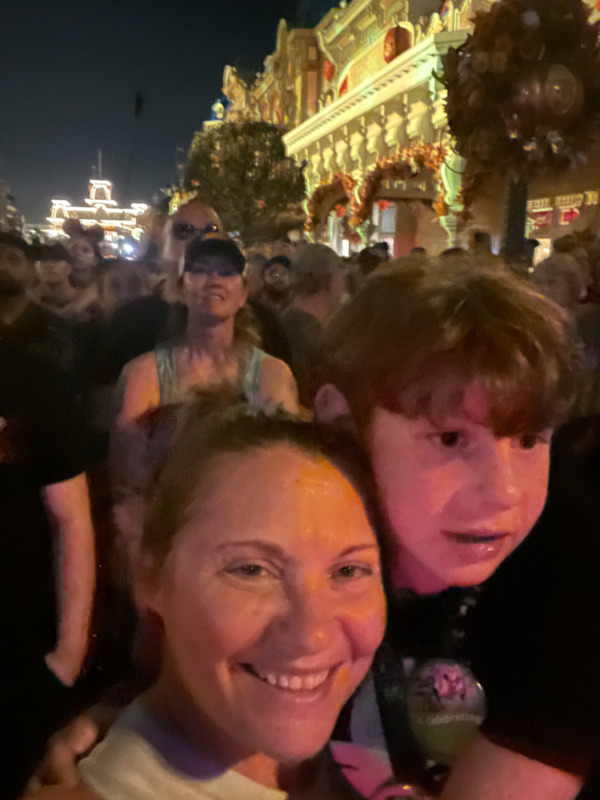 Mother and son watching fireworks at Disney World with tweens